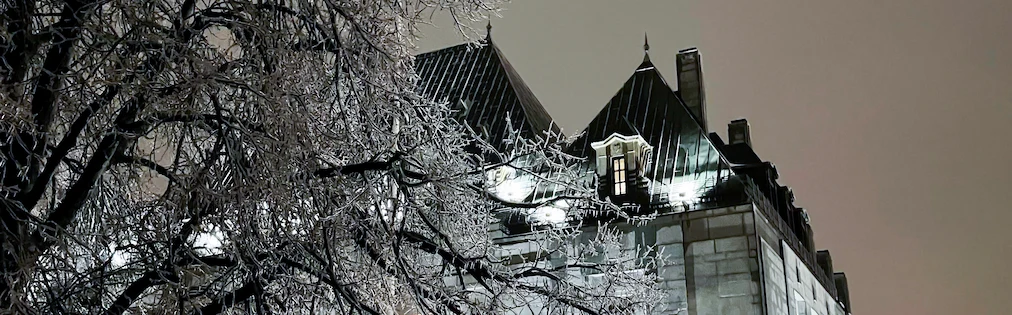 The Supreme Court of Canada building, seen through ice-covered tree branches