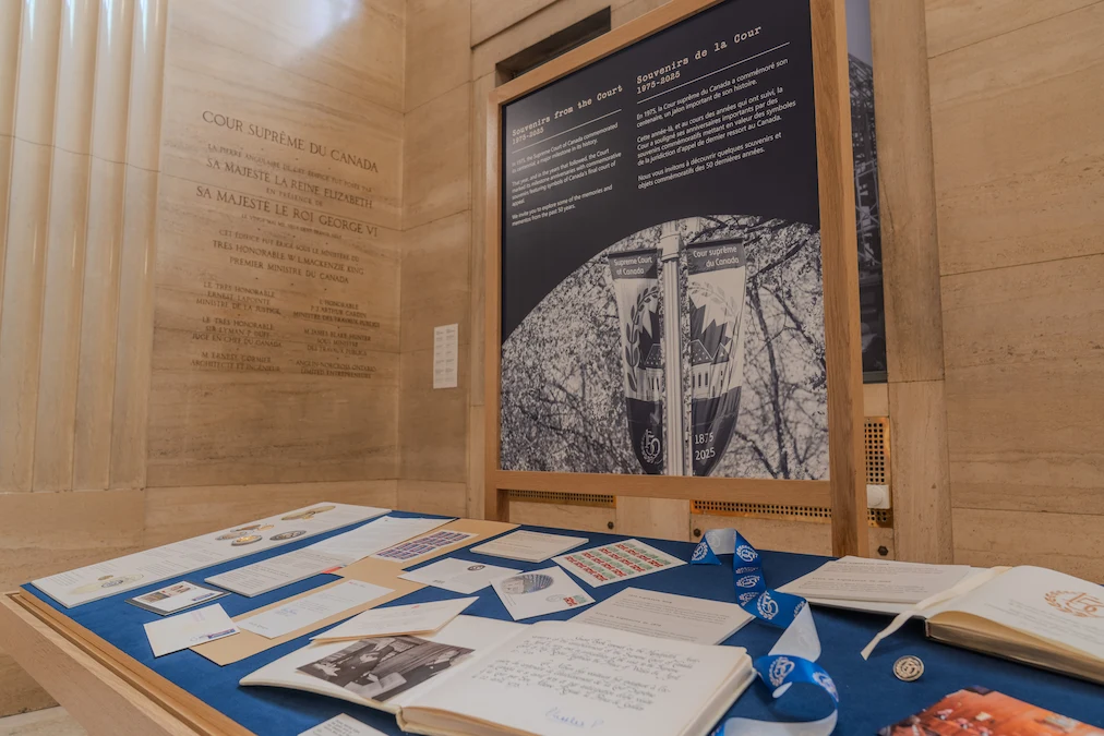 An exhibit case in the grand entrance hall containing books, stamps, coins and photographs