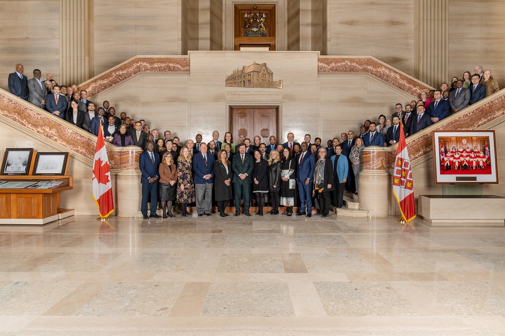 A group photo of members of the diplomatic corps in the grand entrance hall of the Court