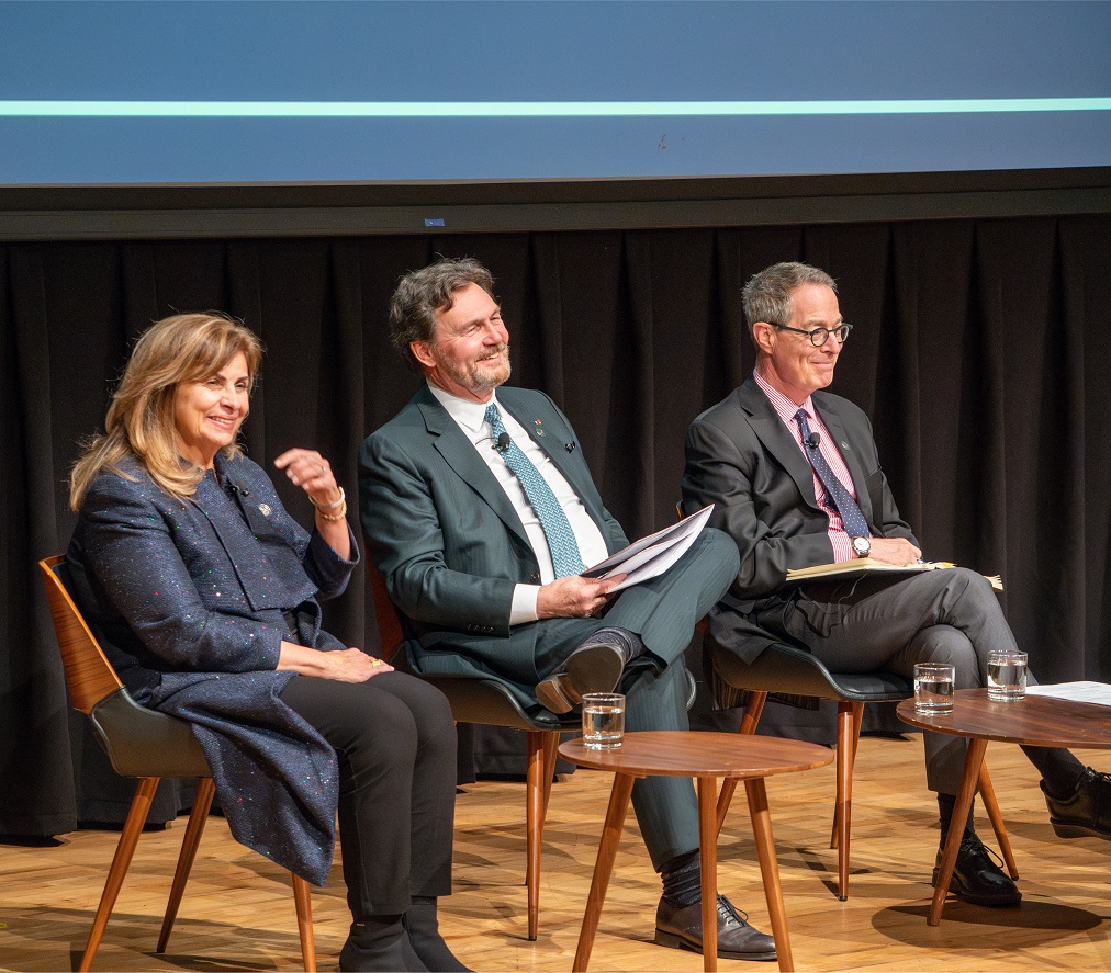 Chief Justice Wagner and Justices Karakatsanis and Kasirer sit on a stage smiling