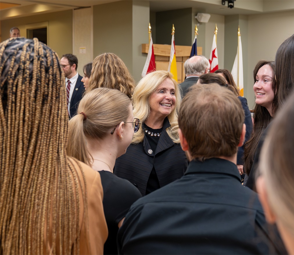 Justice Martin smiles while talking to a group of students