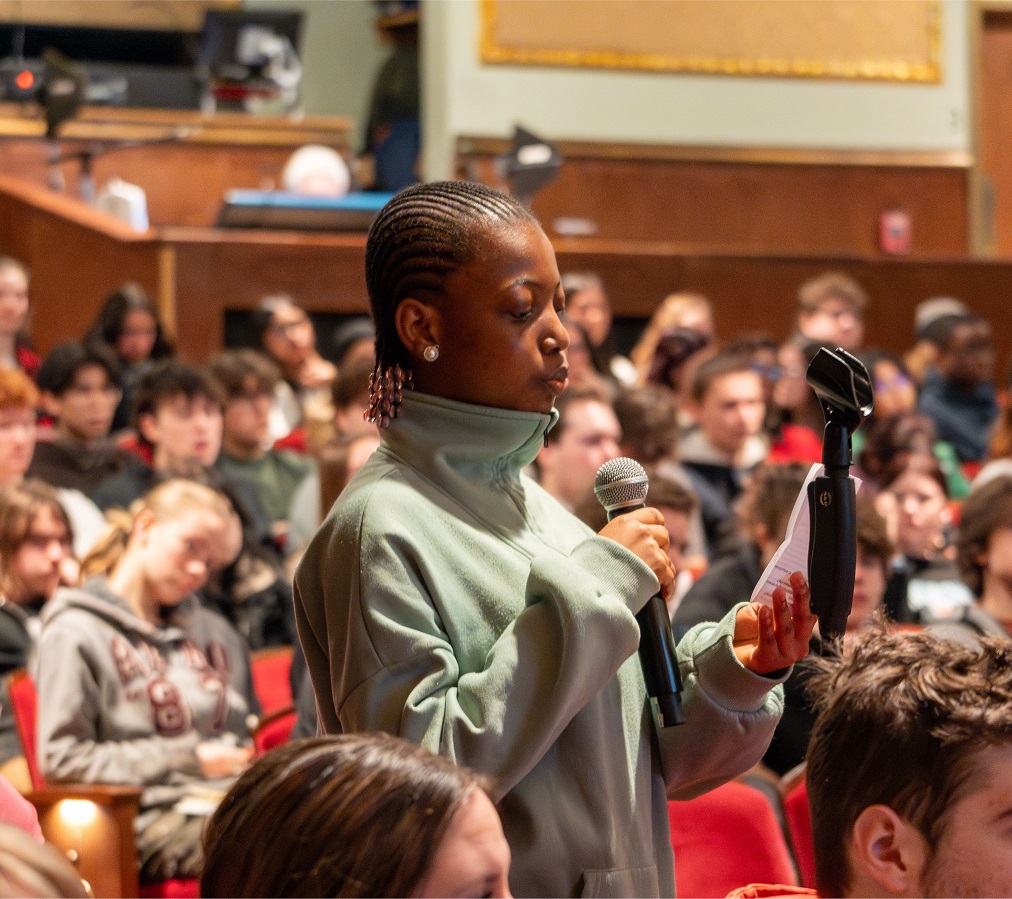An audience member speaks into a microphone