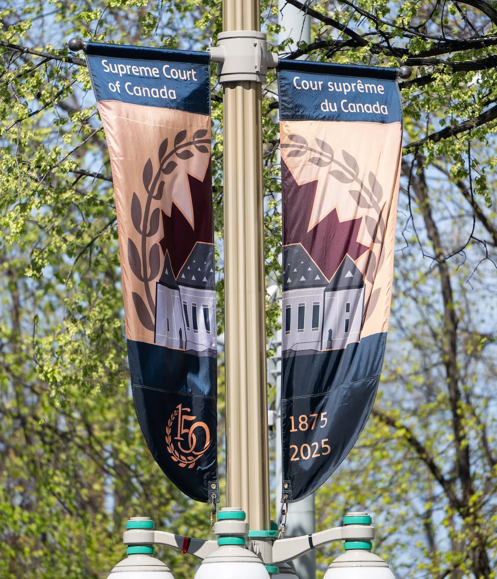 Banners depicting the Supreme Court building hanging from a lamppost 