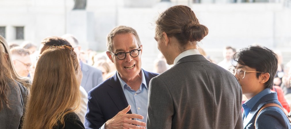 Justice Kasirer speaks with a group of law clerks on the front lawn of the Supreme Court