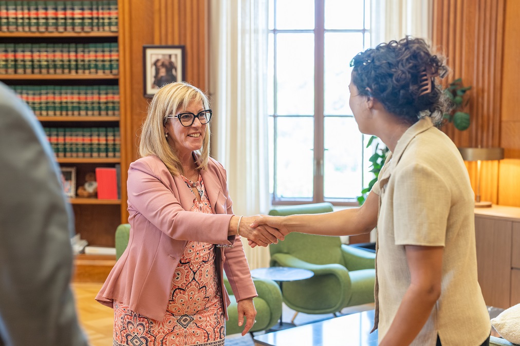 Registrar Chantal Carbonneau shakes hands with a staff member