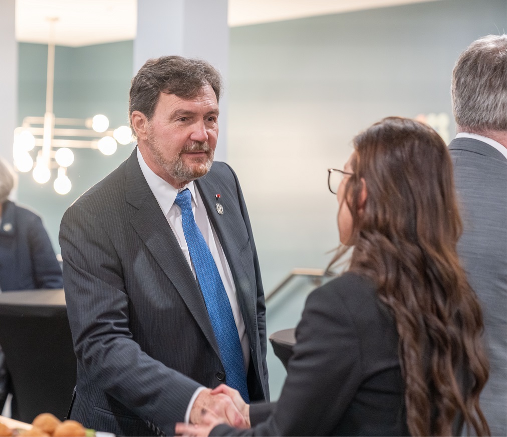 Chief Justice Wagner shakes hands with a woman
