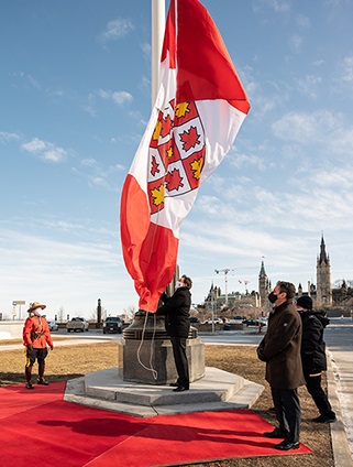 The flag raising outside of the building