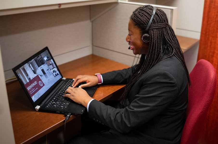 A tour interpreter at her computer